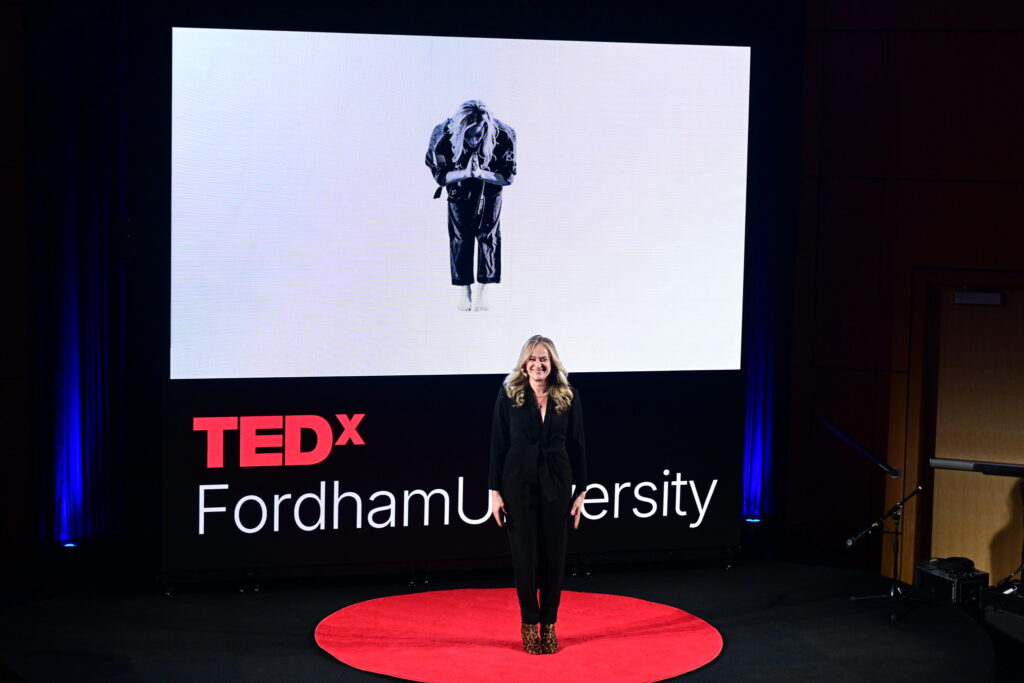 Jenn Cassetta speaking on the TEDxFordhamUniversity stage about resilience, leadership, and overcoming bullies through leverage and strategy.